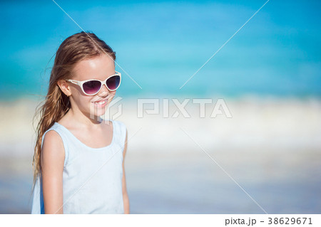 Beautiful little girl in sunglasses at beach 38629671
