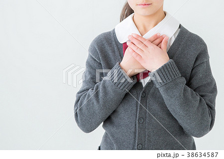 胸に手を当てる制服を着た女の子の写真素材