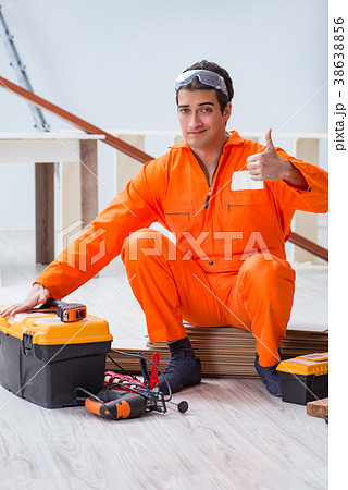 Contractor working on laminate wooden floor  38638856