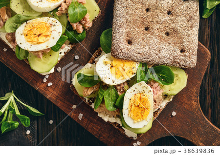 Tuna salad sandwiches with eggs and cucumbers. 38639836