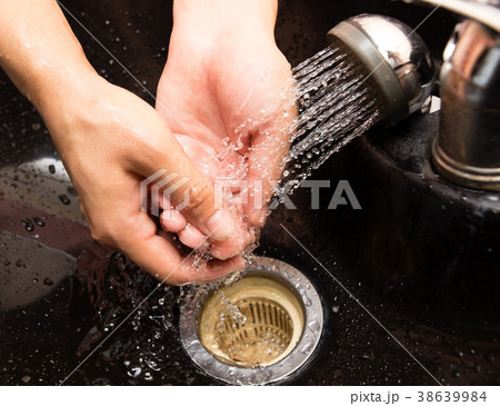 The man washes his hands in the sink The man washes his hands in the sink 38639984