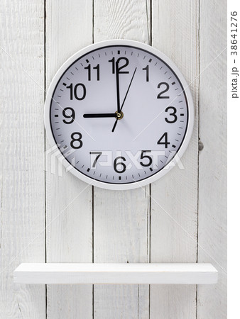 wall clock at wooden shelf 38641276