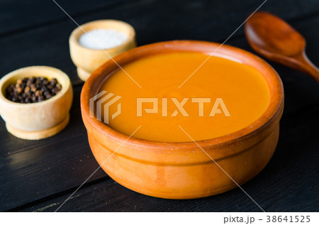 Pumpkin soup served on the table in bowl 38641525