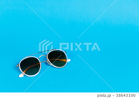 Sunglasses in a white frame isolated on a blue 38643100