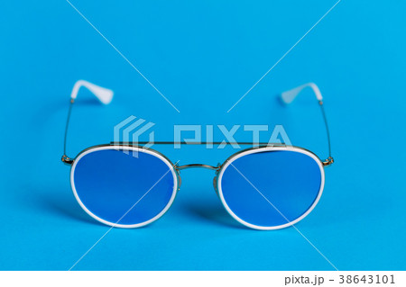 Sunglasses in a white frame isolated on a blue 38643101