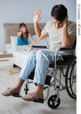 The desperate man on wheelchair with his sad wife 38644512