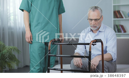 Depressed pensioner sitting on couch and looking 38648397