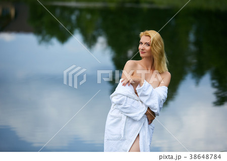 beautiful young woman in shirt by lake 38648784