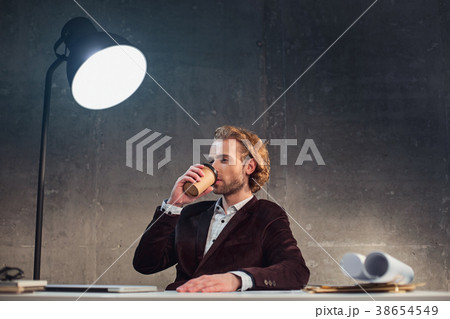 Orderly worker drinking mug of beverage 38654549