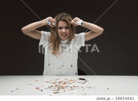 Angry woman trying to quit smoking 38654681