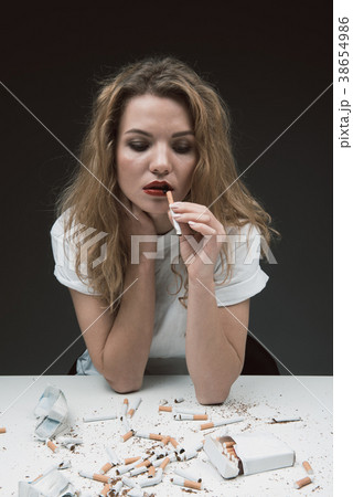 Sad lady with smoke addiction 38654986