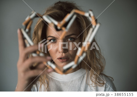 Calm woman being fond of fuming Calm woman being fond of fuming 38655155