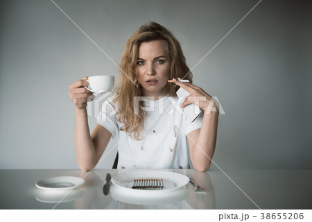 Nicotine abused woman drinking beverage 38655206