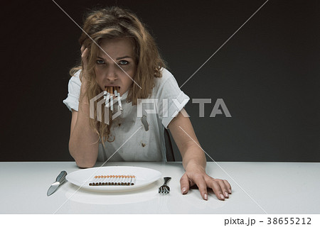 Discontent girl chewing tobacco products Discontent girl chewing tobacco products 38655212