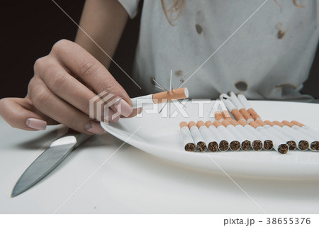 Girl arm with barbed cigarette 38655376