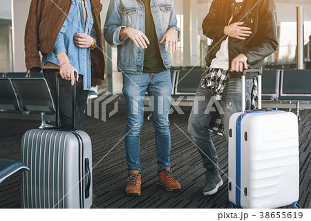 Friends with baggages situating in airport Friends with baggages situating in airport 38655619