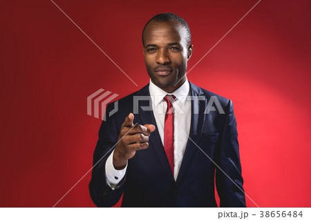Confident businessman in suit is gesticulating 38656484