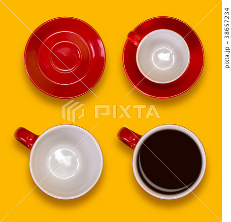 Set of empty and full red cups and a saucers. Coffee set on a yellow background 38657234