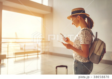 young woman waiting for flying at airport at window with suitcas young woman waiting for flying at airport at window with suitcas 38658870