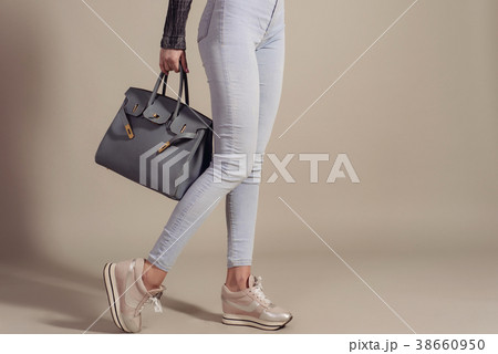 girl in jeans and sneakers holds fashionable bag girl in jeans and sneakers holds fashionable bag 38660950