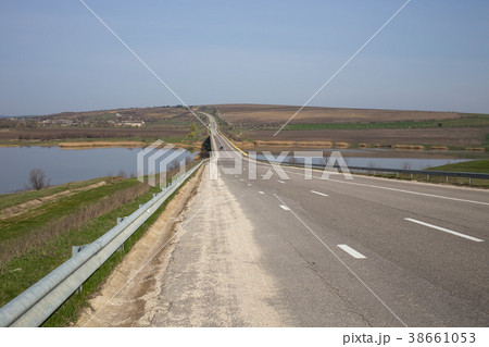 Summer asphalt road near the lake. 38661053