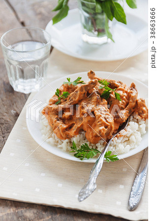 Dish rice with beef stroganoff on a white plate Dish rice with beef stroganoff on a white plate 38663666