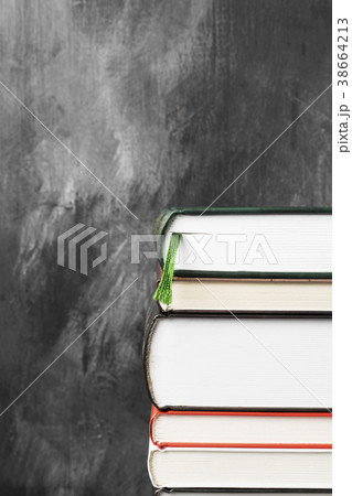 Pile of various books on dark background Pile of various books on dark background 38664213