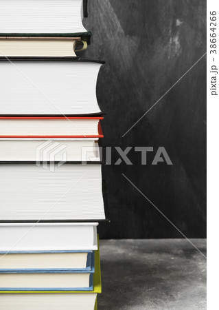 Pile of various books on dark background Pile of various books on dark background 38664266