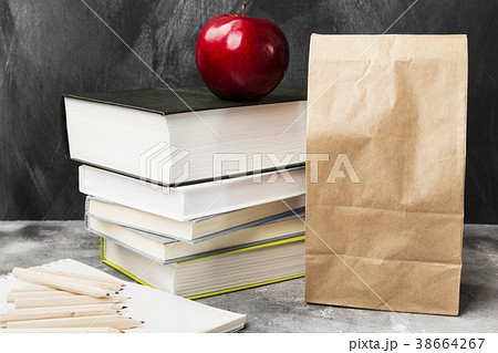 Pile of various books, red apple, package of lunch Pile of various books, red apple, package of lunch 38664267