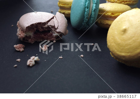 Crumbled macaroons on stylish dark background Crumbled macaroons on stylish dark background 38665117