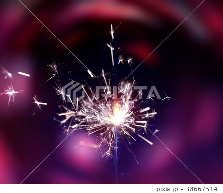 Sparkler fire on blurred pink color background. Sparkler fire on blurred pink color background. 38667514