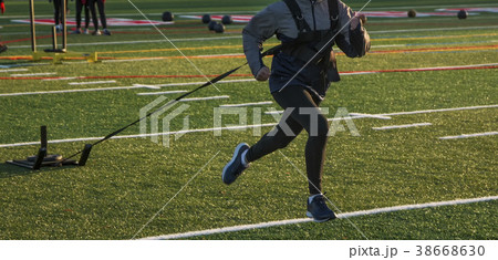 High School runner pulling a wieghted sled 38668630