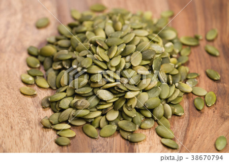 green pumkin seeds on wooden table green pumkin seeds on wooden table 38670794