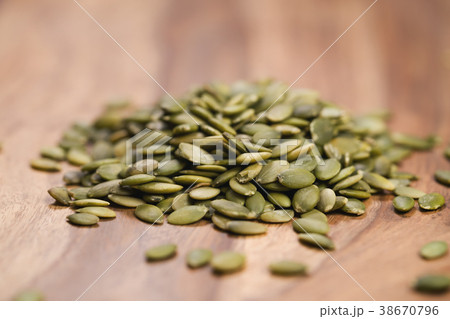 green pumkin seeds on wooden table 38670796