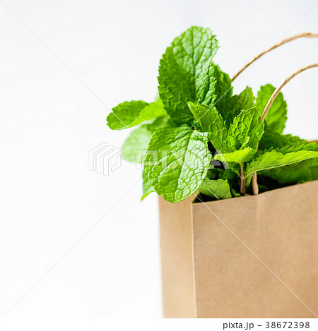 Fresh mint bunch in a paper shopping bag, isolated Fresh mint bunch in a paper shopping bag, isolated 38672398