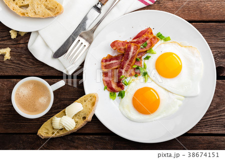 Fried eggs, bacon and italian ciabatta bread 38674151