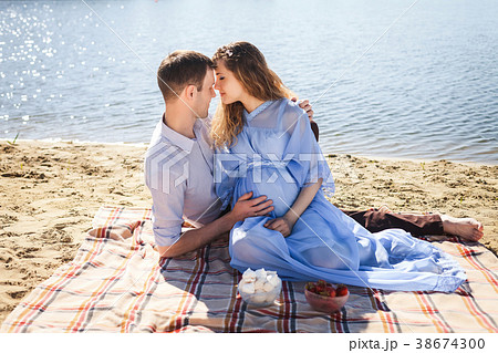 man and girl relaxing on coast river 38674300
