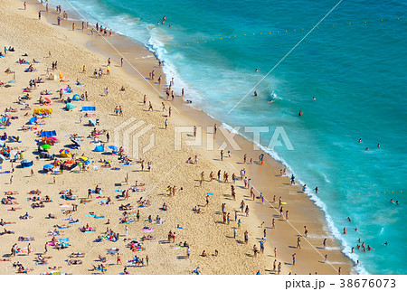 Crowd people ocean beach.  Portugal 38676073