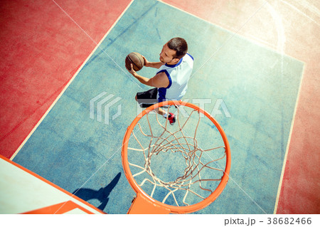 High angle view of basketball player dunking High angle view of basketball player dunking 38682466