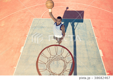 High angle view of basketball player dunking High angle view of basketball player dunking 38682467