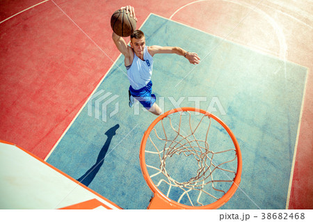 High angle view of basketball player dunking High angle view of basketball player dunking 38682468