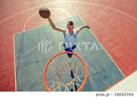 High angle view of basketball player dunking 38682469