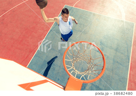 High angle view of basketball player dunking 38682480