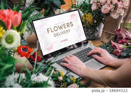 Woman using interface of flower shop 38684322