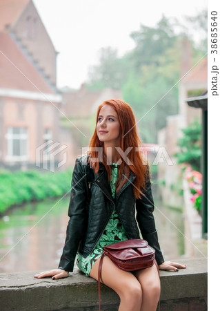 Young redhead girl rest on the street in Brugge Young redhead girl rest on the street in Brugge 38685640