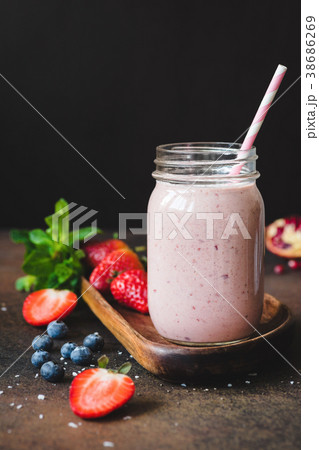 Strawberry smoothie in a jar with drinking straw 38686269