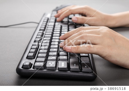 female hands on the keyboard side view 38691518