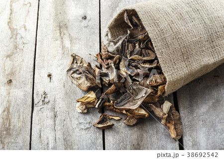 dried mushrooms scattered on the table 38692542