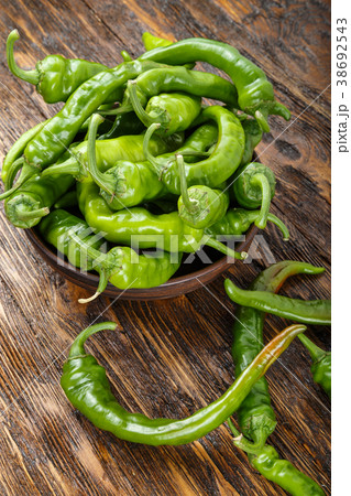 green chili peppers placed in a clay plate green chili peppers placed in a clay plate 38692543