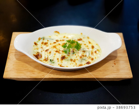 Baked spinach with cheese on white plate 38693753